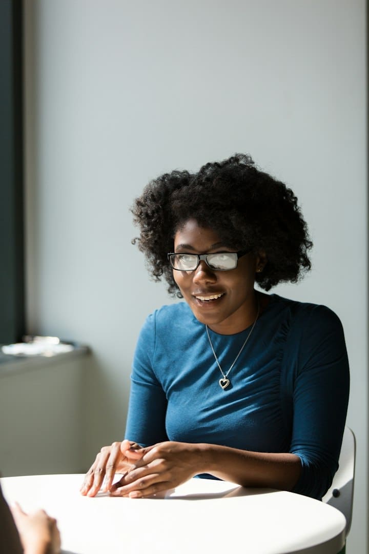 Woman speaking across a table in a business conversation